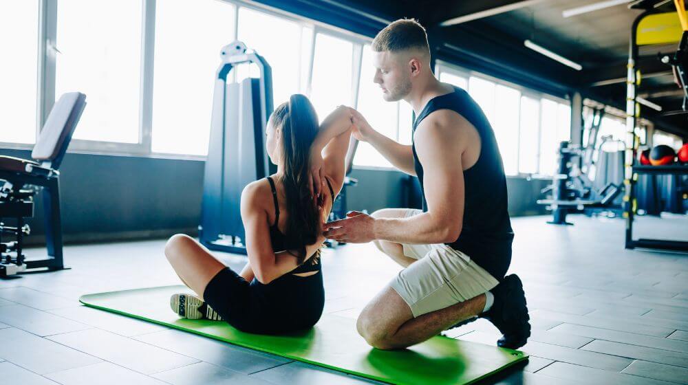 Personal trainer coaching a client during a fitness session.
